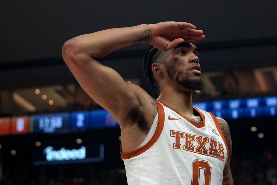 Texas' Timmy Allen salutes the student section Monday night. A crowd of 11,313 were on hand to watch the Longhorns christen Moody Center. Normal capacity for the building is 10,763. "They impacted the game," UT coach Chris Beard said of the crowd. "They were loud. They were having fun."