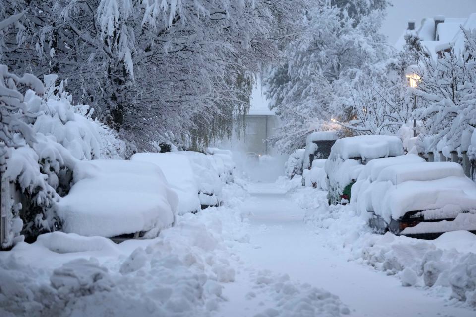 Snow covered cars are parked after heavy snow fall in Munich, Germany, Saturday, Dec. 2, 2023. (AP Photo/Matthias Schrader)