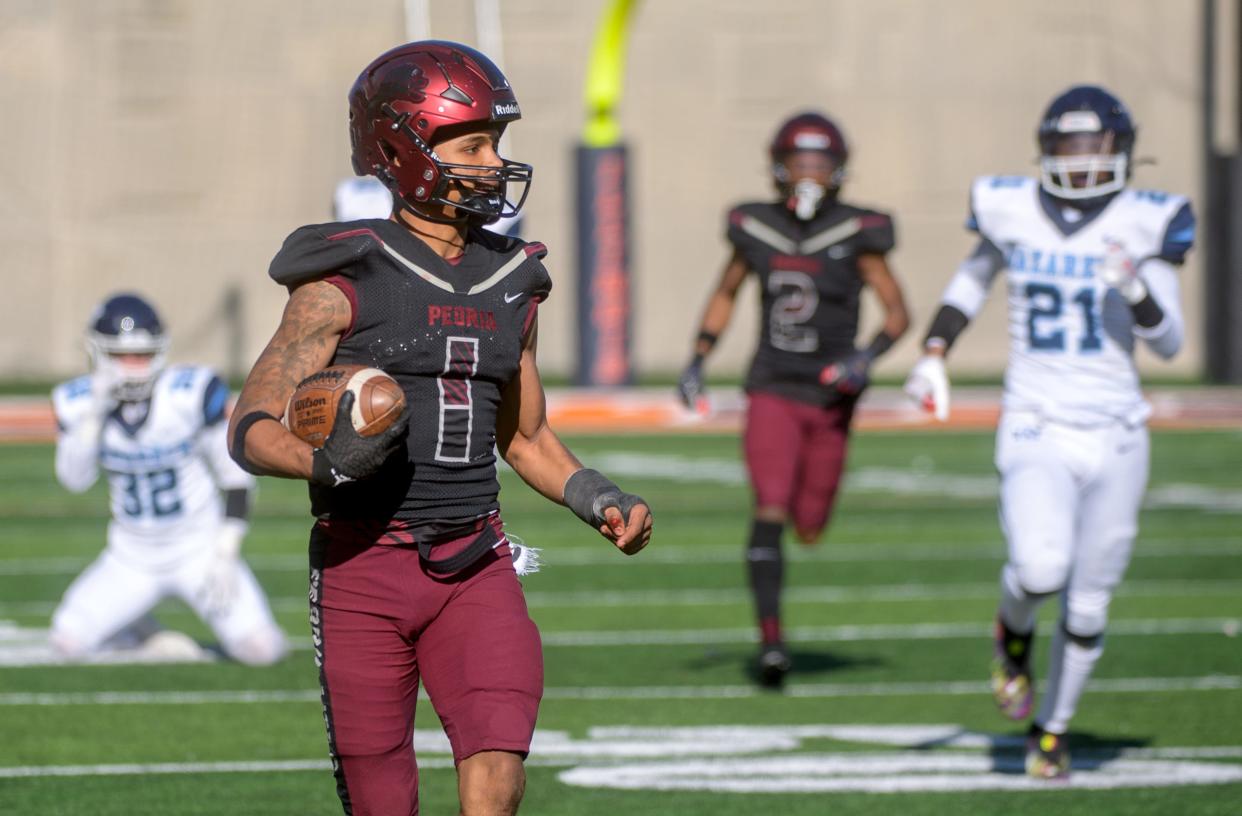 Peoria High's Ricky Hearn (1) runs for a long gain on a kickoff return during the Class 5A football state title game Saturday, Nov. 26, 2022 in Champaign.