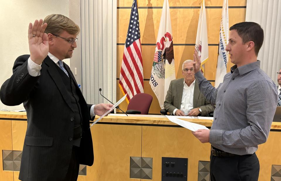New Tazewell County Board member Jon Hopkins of Morton (left) takes his oath of office from Tazewell County Clerk and Recorder of Deeds John Ackerman.