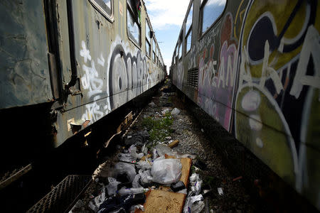 Litter is seen between abandoned railway wagons used as shelter by stranded migrants in the northern city of Thessaloniki, Greece, April 7, 2017. REUTERS/Alexandros Avramidis