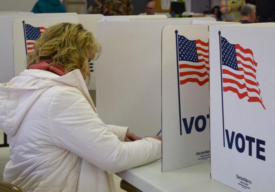 Robyn Tate casts her vote in the primary election at the Holmes County Catholic Center in Millersburg.