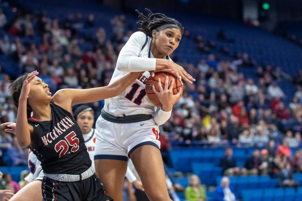 Sacred Heart’s ZaKiyah Johnson (11) grabs a rebound in front of McCracken County’s Destiny Thomas (25) during the Girls’ Sweet 16 championship game at Rupp Arena.