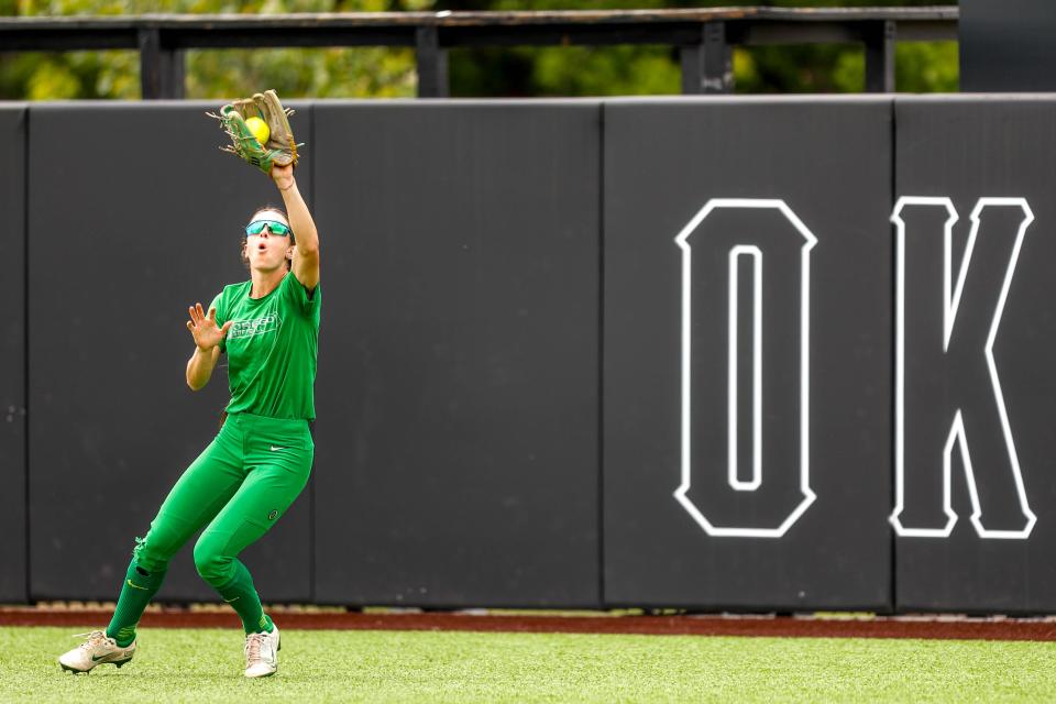 Oregon outfielder Kai Luschar (22) catches a pop fly during a practice at Cowgirl Stadium in Stillwater, Okla., on Wednesday, May 24, 2023.