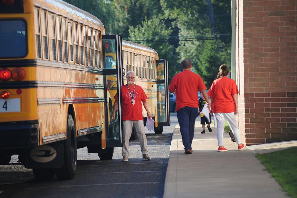 Staff members assist bus drivers Thursday, Aug. 18, 2022, the first day of classes at Alliance Elementary School. Students in the district have staggered starting days at the beginning of the 2022-23 school year.