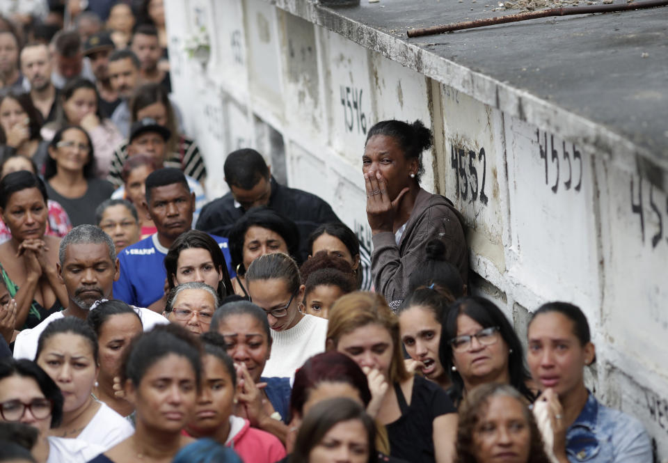 Relatives and friends of the late 8-year-old Ágatha Sales Felix attend her burial at a cemetery in Rio de Janeiro, Brazil, Sunday, Sept. 22, 2019. Félix was hit by a stray bullet Friday amid what police said was shootout with suspected criminals. However, residents say there was no shootout, and blame police. (AP Photo/Silvia Izquierdo)