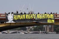 <p>A giant “Human Rights Nightmare” banner is unfurled by Amnesty International activists across the river Thames on Vauxhall Bridge to protest against the visit of President Donald Trump, in London, Thursday, July 12, 2018. (Photo: Luca Bruno/AP) </p>