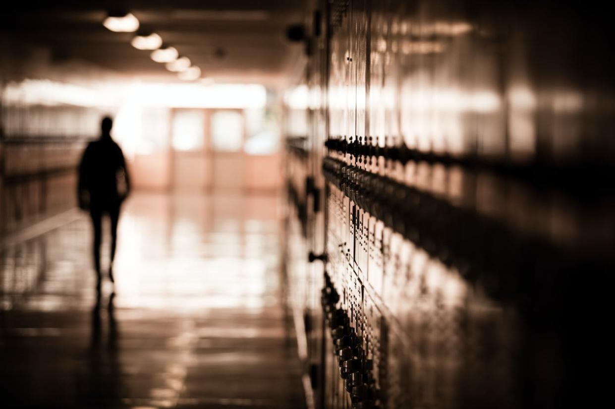 Physical assaults against educators are on the rise. <a href="https://www.gettyimages.com/detail/photo/silhouetted-man-in-the-building-royalty-free-image/92297581?adppopup=true" rel="nofollow noopener" target="_blank" data-ylk="slk:Hal Bergman Photography via Getty Images;elm:context_link;itc:0;sec:content-canvas" class="link ">Hal Bergman Photography via Getty Images</a>