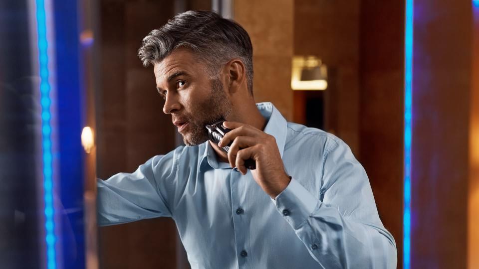man shaving with an electric razor