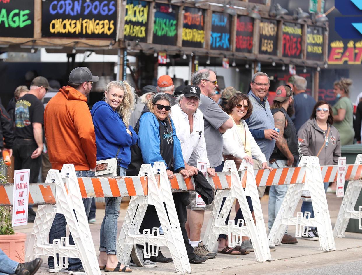 Spectators watch from behind barricades during Bike Week in Daytona Beach on Monday, March 8, 2021. (Stephen M. Dowell/Orlando Sentinel)