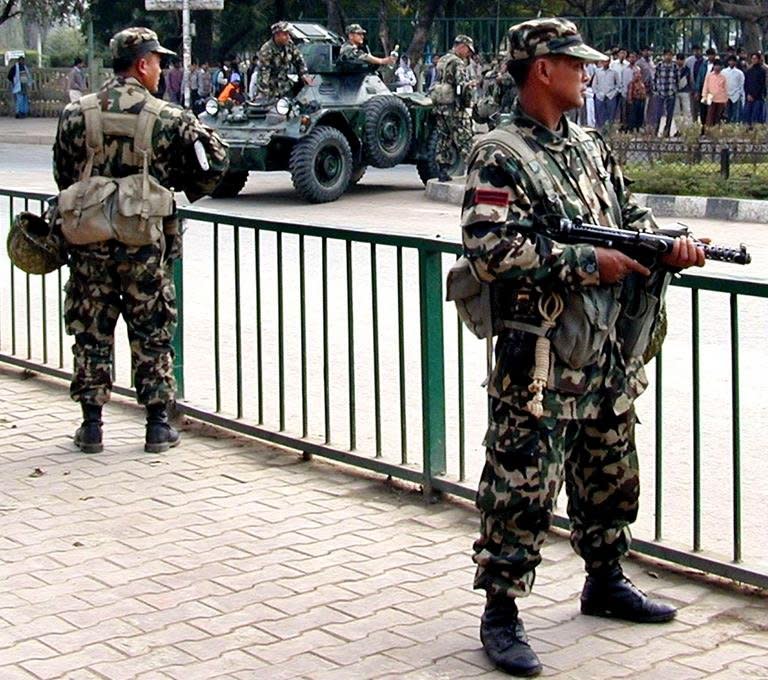 File picture. Army personnel stand guard at a street in Kathmandu on December 7, 2001 in anticipation of a Maoist attack. More than 16,000 people died in conflict between Maoist rebels and the state, which ended in 2006