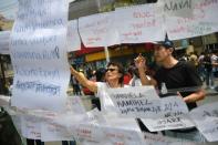 Residents look at lists with the names of people missing since the quake in Mexico City