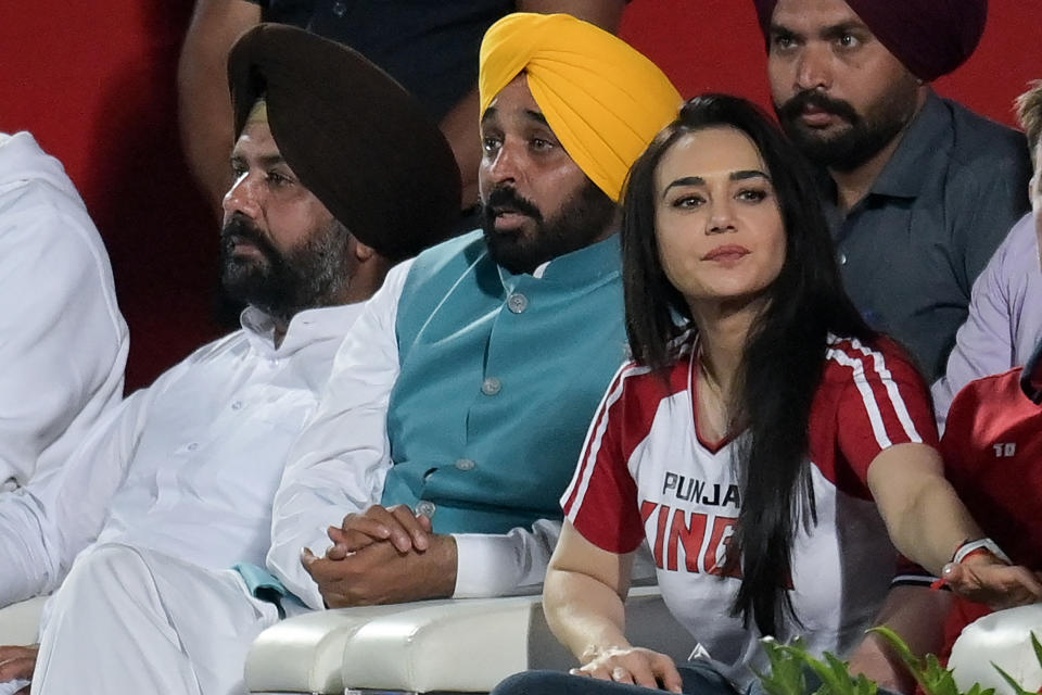 Chief minister of India's Punjab state Bhagwant Mann (C) and Preity Zinta (front, R), Co-owner of Punjab Kings' IPL team watch the Indian Premier League (IPL) Twenty20 cricket match between Punjab Kings and Rajasthan Royals at the Himachal Pradesh Cricket Association Stadium in Dharamsala on May 19, 2023. (Photo by Money SHARMA / AFP) (Photo by MONEY SHARMA/AFP via Getty Images)