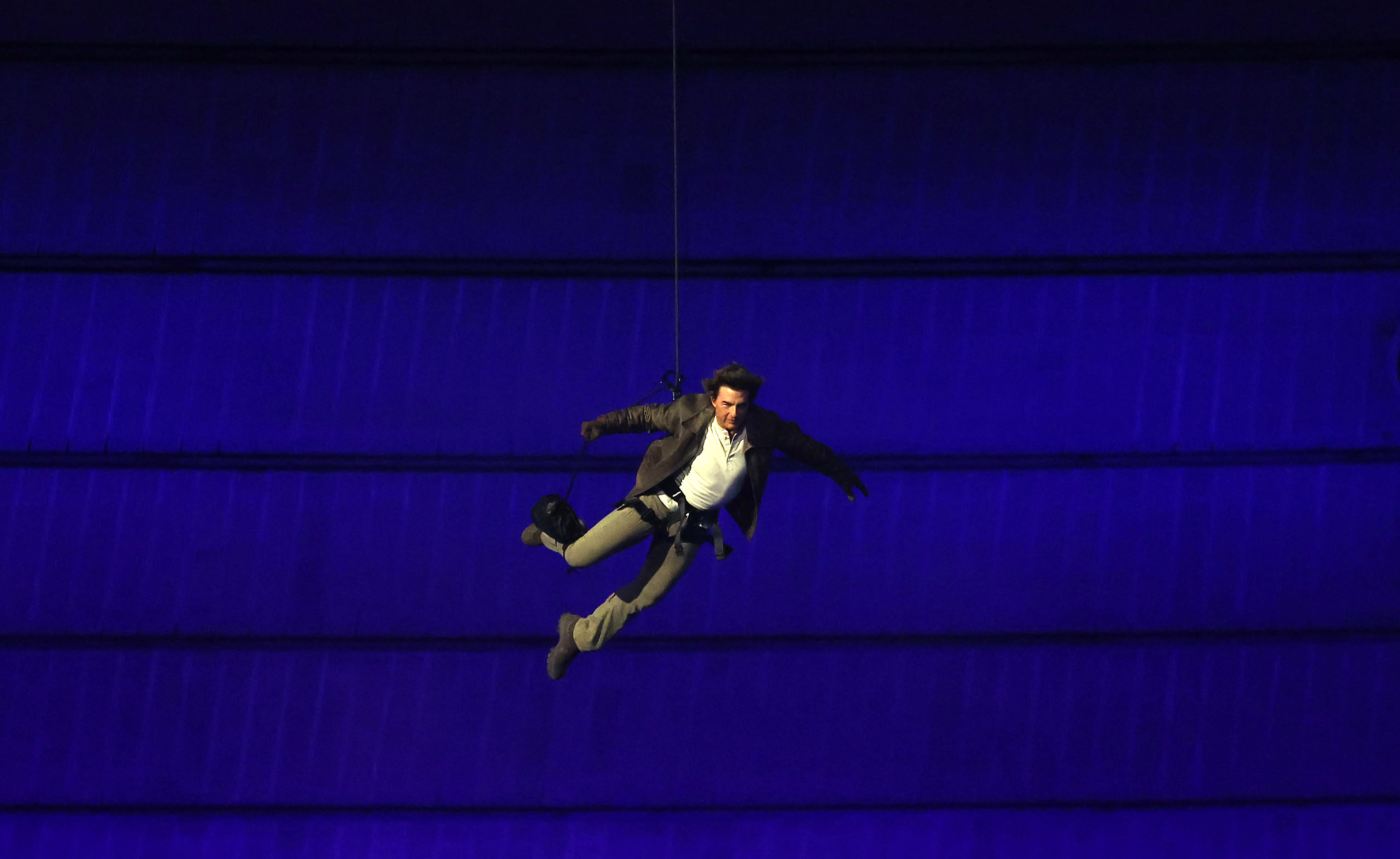 PARIS, FRANCE - AUGUST 11: American Actor and Film Producer Tom Cruise repels into the stadium during the Closing Ceremony of the Olympic Games Paris 2024 at Stade de France on August 11, 2024 in Paris, France. (Photo by Carl Recine/Getty Images)