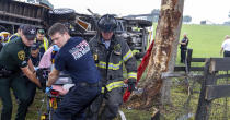 This photo provided by the Marion County Fire Rescue Dept. shows crews from Marion County Fire Rescue and the Marion County Sheriff’s Office assisting victims after a bus carrying farmworkers crashed and overturned early Tuesday, May 14, 2024 near Ocala, Fla. The Florida Highway Patrol says eight people were killed and nearly 40 others were injured. (Marion County Fire Rescue Dept. via AP)