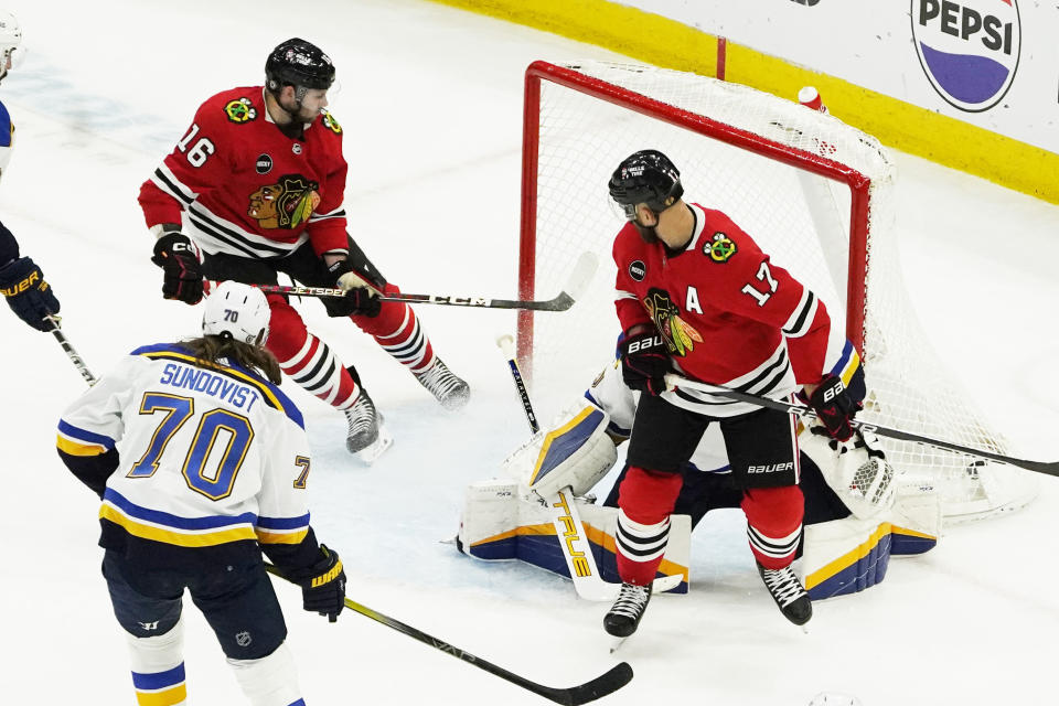 Chicago Blackhawks center Jason Dickinson (16) scores a goal on St. Louis Blues goaltender Jordan Binnington during the second period of an NHL hockey game Saturday, Dec. 9, 2023, in Chicago. (AP Photo/David Banks)