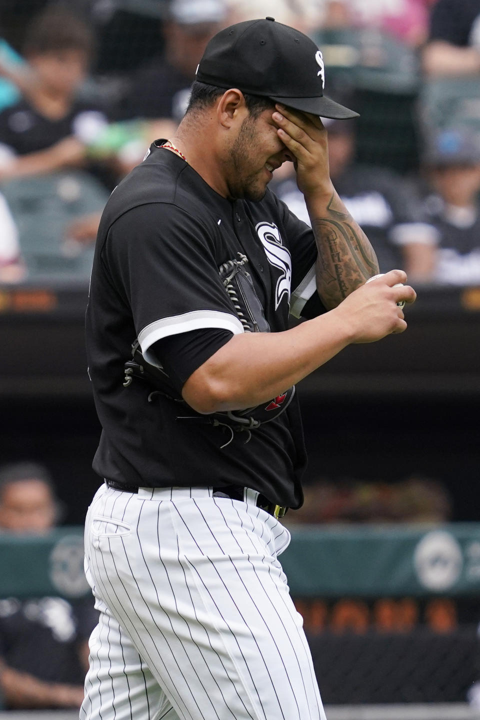 Chicago White Sox relief pitcher Jose Ruiz wipes his face after Baltimore Orioles' Austin Hays hit a three-run double during the seventh inning of a baseball game in Chicago, Saturday, June 25, 2022. (AP Photo/Nam Y. Huh)