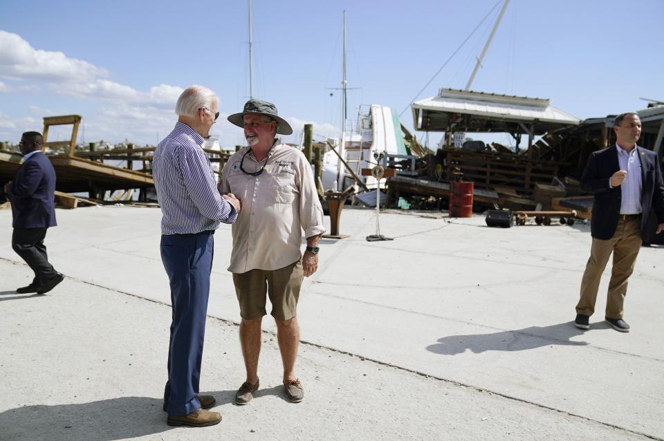 President Joe Biden talks with Fort Myers Beach Mayor Ray Murphy as he tours the area impacted by Hurricane Ian on Wednesday, Oct. 5, 2022, in Fort Myers Beach, Fla. (AP Photo/Evan Vucci)