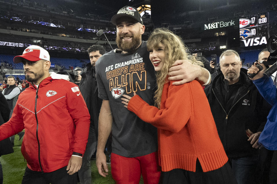 FILE - Kansas City Chiefs tight end Travis Kelce walks with Taylor Swift following the AFC Championship NFL football game between the Baltimore Ravens and the Kansas City Chiefs, Sunday, Jan. 28, 2024, in Baltimore. As the Kansas City Chiefs head to the Super Bowl, baseless conspiracy theories are spreading on social media suggesting that the romance between megastar Taylor Swift and Kansas City Chiefs tight end Travis Kelce is part of a secret plot to help President Joe Biden get reelected in 2024. (AP Photo/Julio Cortez, File)