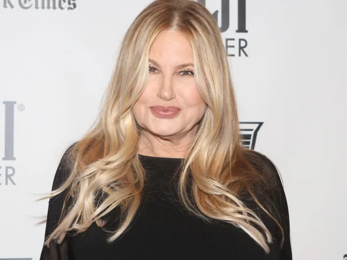 Jennifer Coolidge poses on the red carpet in a black long-sleeved dress.