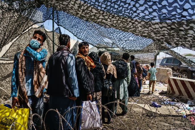 Afghan refugees leave a processing line before moving to a waiting area for a flight out of Kabul, Afghanistan, on Aug. 25. (Photo: Marcus Yam/Los Angeles Times via Getty Images)