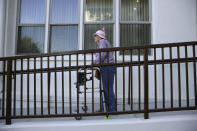 Patty Zahnow, 77, makes her way down a ramp at the Villas at Hamilton housing complex for low income seniors Wednesday, Oct. 30, 2019, in Novato, Calif. Zahnow was one of many seniors at the complex that was stuck in the dark during the recent power blackouts. Pacific Gas & Electric officials said they understood the hardships caused by the blackouts but insisted they were necessary. (AP Photo/Eric Risberg)