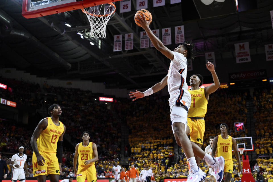 Illinois guard Terrence Shannon Jr., front, goes to the basket for a layup during the first half of an NCAA college basketball game against Maryland, Friday, Dec. 2, 2022, in College Park, Md. (AP Photo/Terrance Williams)