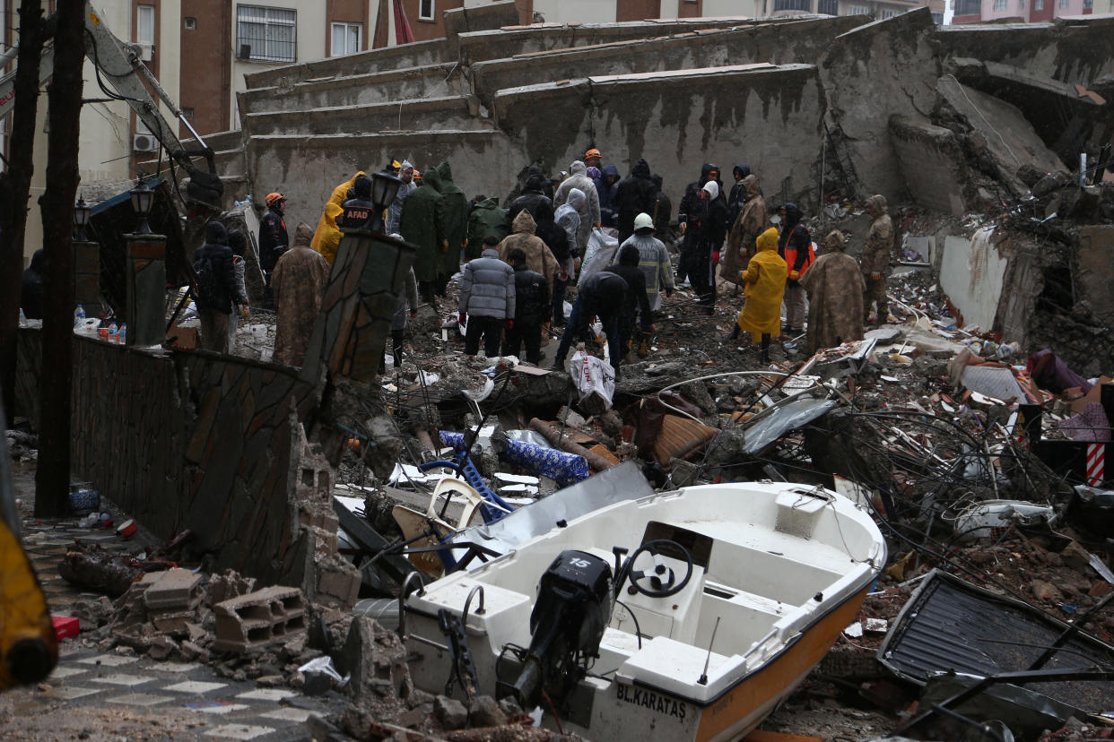 Rescuers at the site of a collapsed building in Adana, Turkey. 