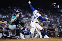 Arizona Diamondbacks' Christian Walker (53) strikes out as Seattle Mariners catcher Tom Murphy, left, holds the baseball during the seventh inning of a game Friday, Sept. 3, 2021, in Phoenix. (AP Photo/Ross D. Franklin)