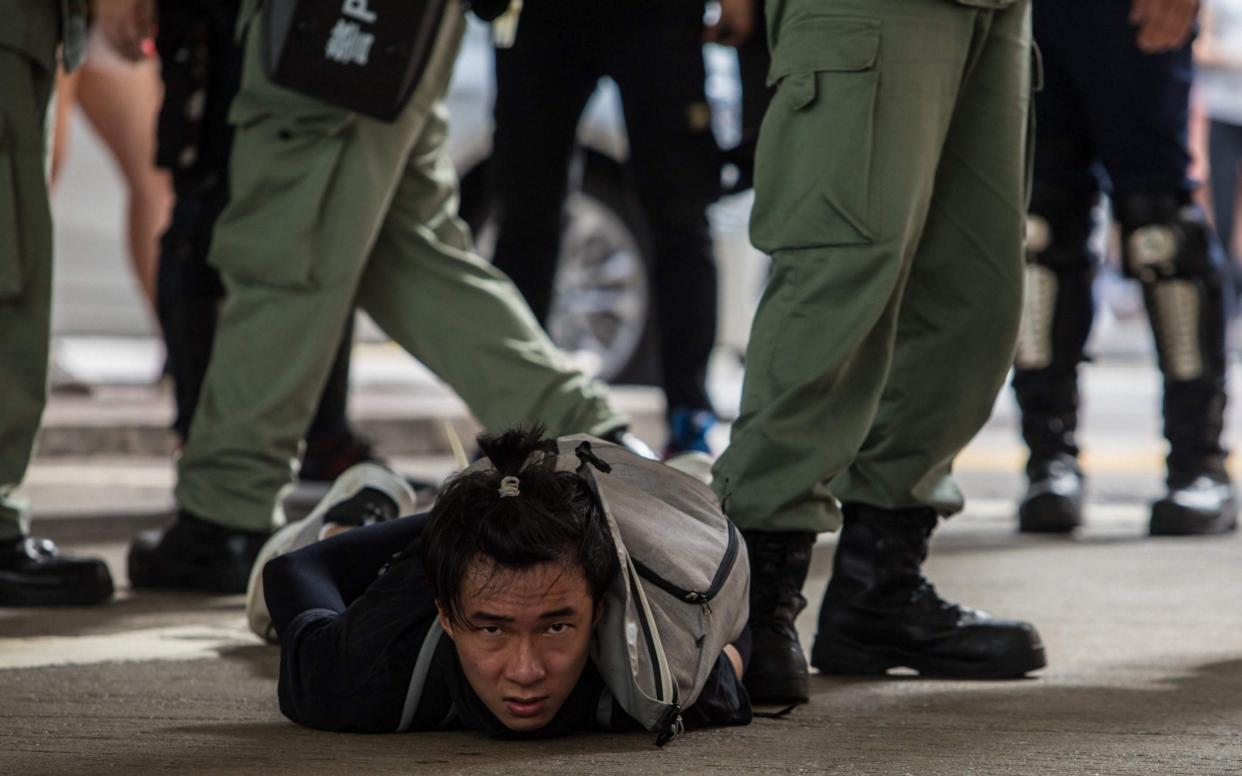 Riot police detain a man during a protest in July 2020 against the new national security law in Hong Kong - DALE DE LA REY /AFP