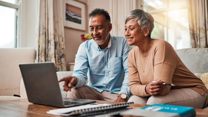 A husband and wife check on their retirement account and emergency fund balances.
