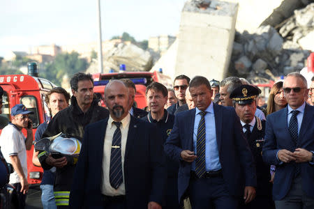 Italian Prime Minister Giuseppe Conte arrives to inspect the site of the collapsed Morandi Bridge in the port city of Genoa, Italy August 14, 2018. REUTERS/Massimo Pinca
