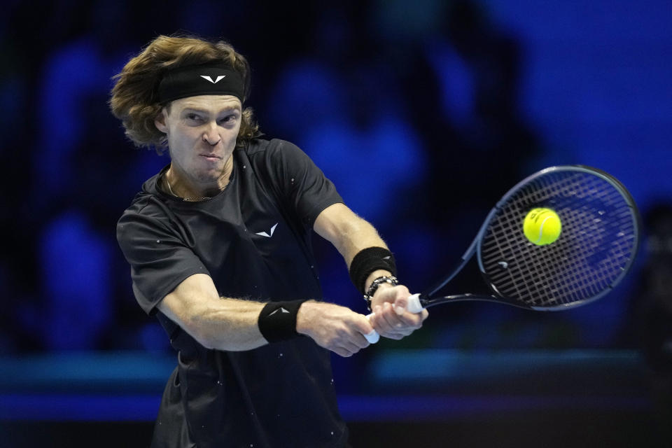 Russia's Andrej Rublev returns the ball to Spain's Carlos Alcaraz during their singles tennis match of the ATP World Tour Finals at the Pala Alpitour, in Turin, Italy, Wednesday, Nov. 15, 2023. (AP Photo/Antonio Calanni)