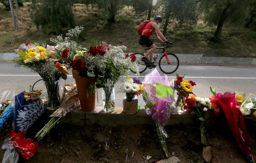 LOS ANGELES, CALIF. - APR. 18, 2022. Flowers mark the location where bicyclist Andrew Jelmert, 77, was killed after being struck by a vehicle while participating in the AIDS/LifeCycle charity ride in Griffith Park on Saturday, Apr. 16,. 2022. The Los Angeles Police Department has arrested the driver who was booked on suspicion of gross vehicular manslaughter. Police said the driver left the scene without providing aid or identifying himself. (Luis Sinco / Los Angeles Times)