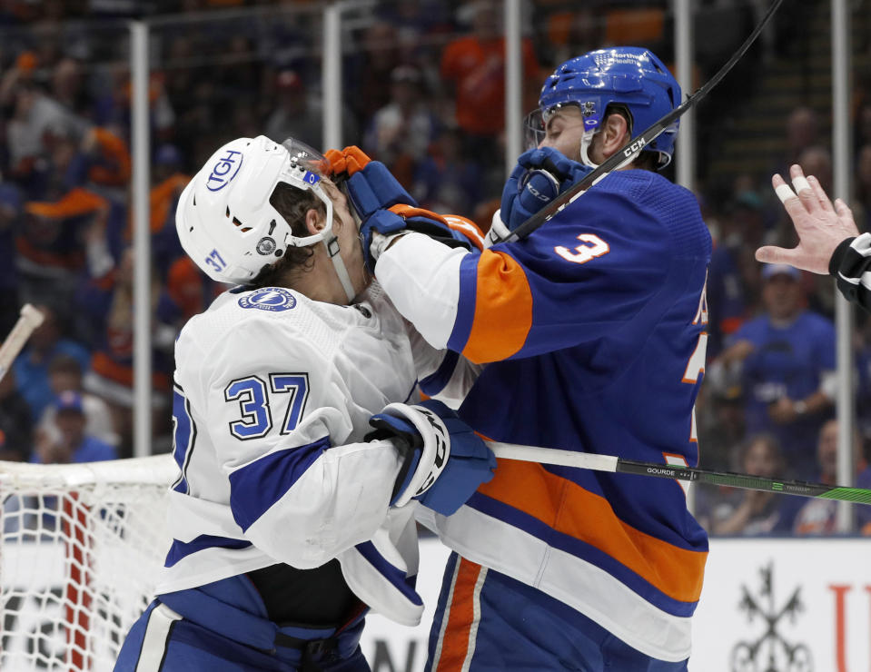 Tampa Bay Lightning center Yanni Gourde (37) and New York Islanders defenseman Adam Pelech (3) shove each other after a whistle during the first period in Game 4 of the NHL hockey Stanley Cup semifinals, Saturday, June 19, 2021, in Uniondale, N.Y. (AP Photo/Jim McIsaac)