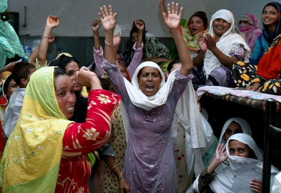 FILE - In this July 8, 2006 file photo, women prisoners celebrate the news of their release on bail, at Adiala Jail in Rawalpindi, Pakistan. Kanizan Bibi, charged with murdering her employer's wife and five children, remains a prisoner on death row for the last 29 years. She’s one of more than 600 mentally ill prisoners in Pakistan’s overcrowded prisons. (AP Photo/Anjum Naveed,file)