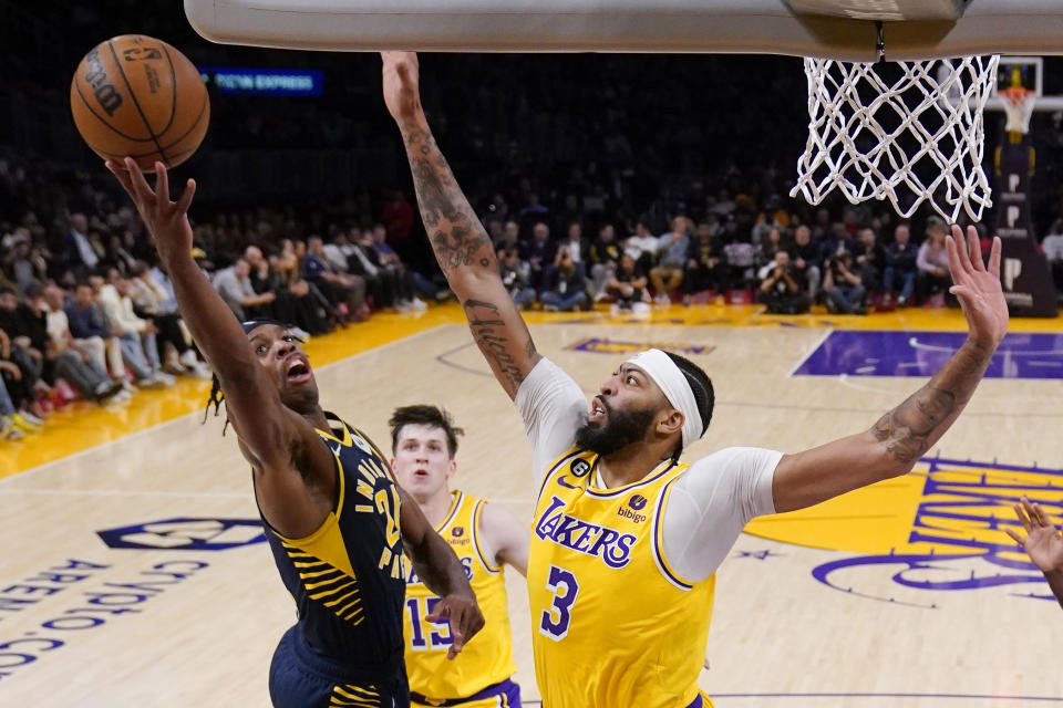 Indiana Pacers&#39; Buddy Hield, left, shoots as Los Angeles Lakers forward Anthony Davis defends during the first half of an NBA basketball game Monday, Nov. 28, 2022, in Los Angeles. (AP Photo/Mark J. Terrill)