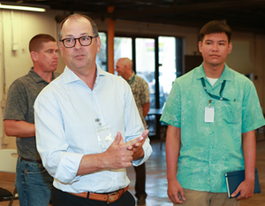 Chris Kastner, president and CEO of HII, speaks with HII interns in Hawaii during his tour of HII facilities.