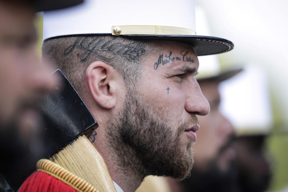 <p>A member of the 2nd Foreign Infantry Regiment wears a tattoo with the legion’s motto, “March or Die,” as he takes part in the annual Bastille Day military parade on the Champs-Élysées in Paris on July 14, 2018. (Photo: Thomas Samson/AFP/Getty Images) </p>