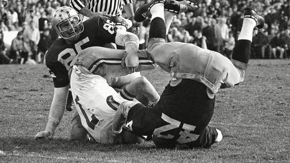 Mandatory Credit: Photo by Anonymous/AP/Shutterstock (6637112a)LSU quarterback Bert Jones (7) is upset and thrown for an eight yard loss in third quarter by Notre Dame's Tim Kelly (42) as Walt Patulski (85) also gets into the action in South Bend, Ind.