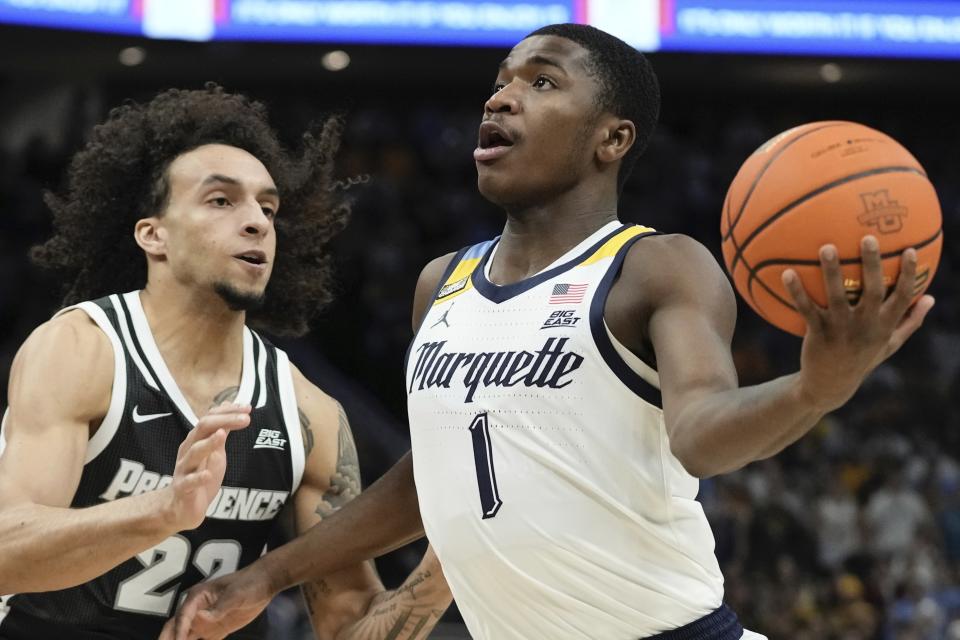 Marquette's Kam Jones drives past Providence's Devin Carter during the first half of an NCAA college basketball game Wednesday, Jan. 18, 2023, in Milwaukee. (AP Photo/Morry Gash)