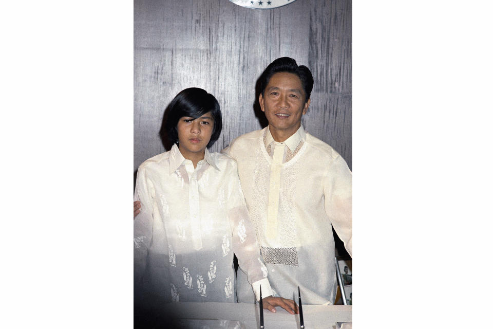 FILE - President Ferdinand Marcos of the Philippines, right, poses with his only son Ferdinand 'Bongbong" Marcos Jr., on Jan. 18, 1972, in Manila, Philippines. The son of the late dictator and his running mate Sara, who is the daughter of the outgoing President Rodrigo Duterte, are leading pre-election surveys despite his family's history. (AP Photo/Jess Tan Jr.,File)