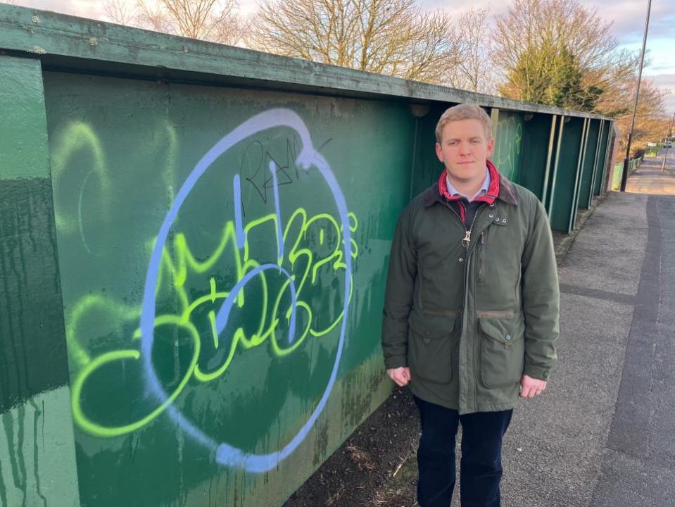 York Press: Cllr Ashley Mason with graffiti at the St Helens Road railway bridge