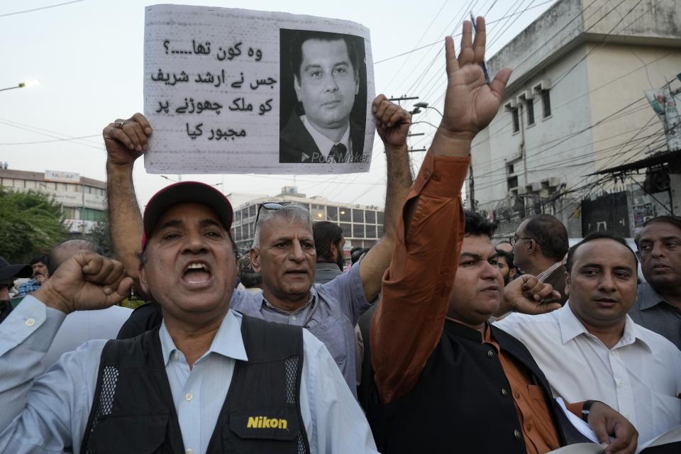Journalists hold a demonstration to condemn the killing of senior Pakistani journalist Arshad Sharif by Kenyan police, in Lahore, Pakistan, Monday, Oct. 24, 2022. Sharif, 50, had been in hiding abroad after leaving Pakistan to avoid arrest on charges of criticizing his country's powerful military. Sharif was shot and killed by police after the car he was in sped up instead of halting at a roadblock near Nairobi, the police said. The police said it was a case of "mistaken identity" during a search for a similar car involved in a case of child abduction. (AP Photo/K.M. Chaudary)