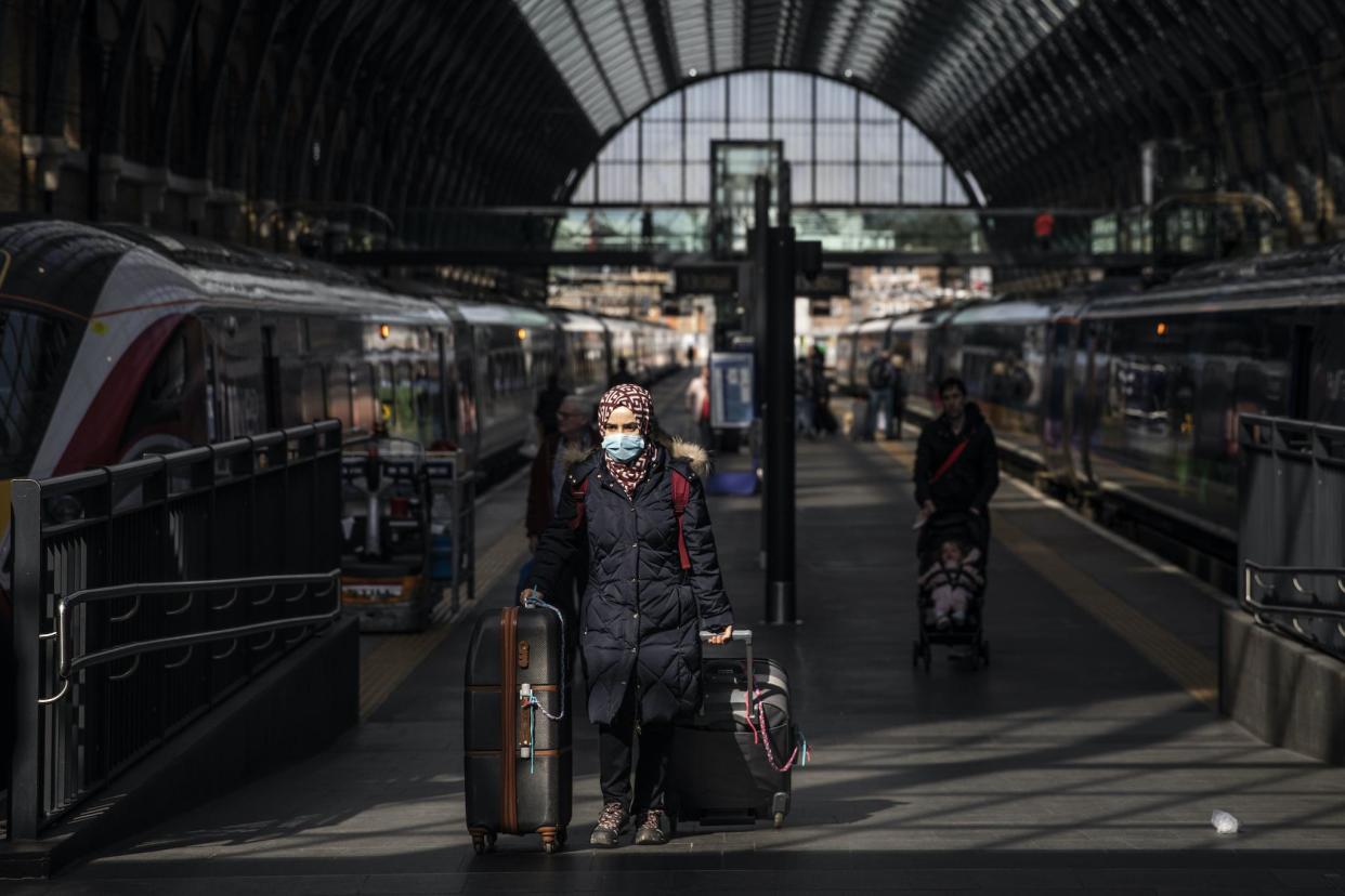 A passenger wears a protective mask at King's Cross train station on March 16, 2020 in London, England: Dan Kitwood/Getty Images