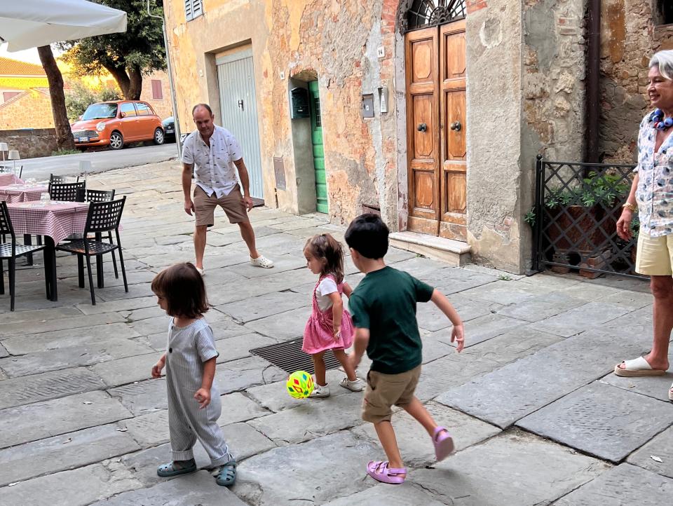 The author's kids playing soccer on a street