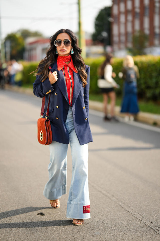 A guest wears a Vuitton brown monogram pyjama outfit, outside