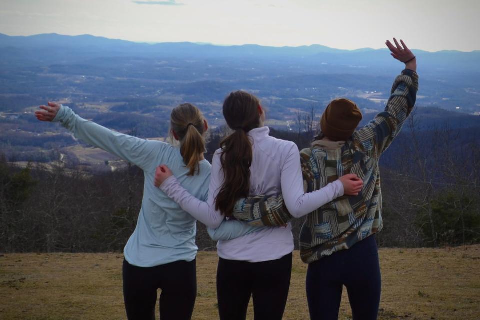 Hikers take in the view from the top of Bearwallow Mountain Trail in Hendersonville. Get Outside WNC offers guided social hikes for all ages and abilities to encourage a love for the outdoors and teach the importance of conservation.