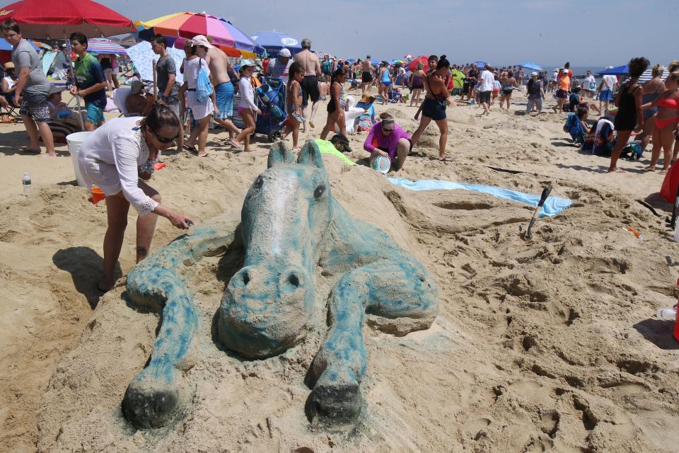 Kristen Galiastro of Freehold Twp., Robin Bhattacharyya of Lakewood and Corryn DeLorenzo of Middletown create a â€œSea Horseâ€ sand sculpture during the 33rd annual New Jersey Sandcastle Contest on the 18th Avenue Beach in Belmar, NJ Wednesday July 17, 2019.