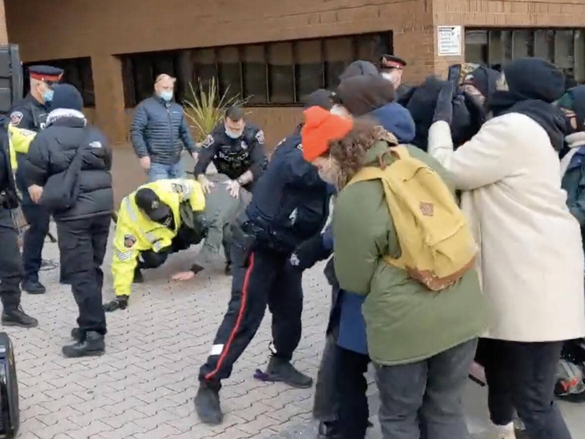 A video shared on social media by the Hamilton Centre for Civic Inclusion showed several protesters being arrested outside of the central police station on Nov. 26. (Hamilton Centre for Civic Inclusion/Twitter - image credit)